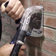 Person using a tool with 'Alpha' branding on a brick wall