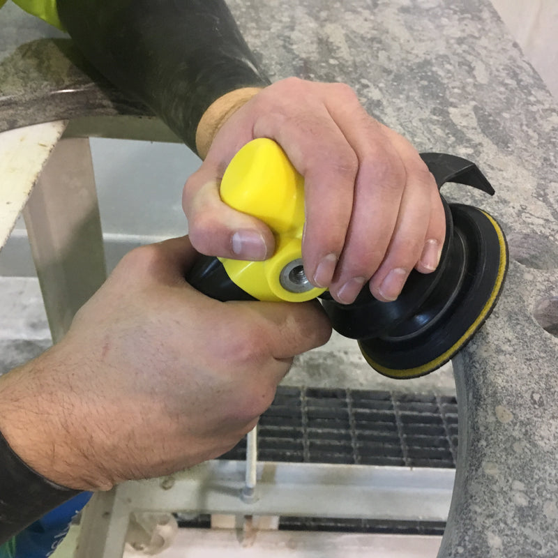 Person using a yellow AIR-830 Polisher on a granite countertop