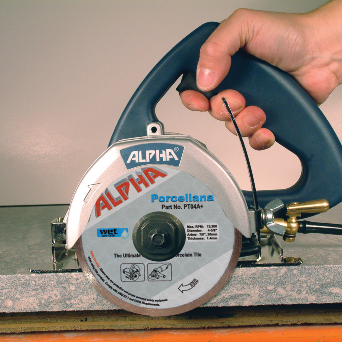 Hand holding a AWS-110 circular saw with Alpha Porcellana Diamond Blade