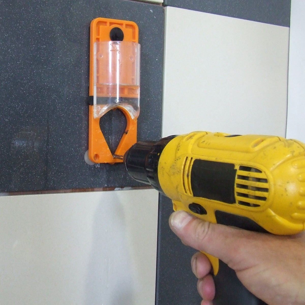 Alpha drill bit water delivery system attached to a wall delivering water to a dril bit