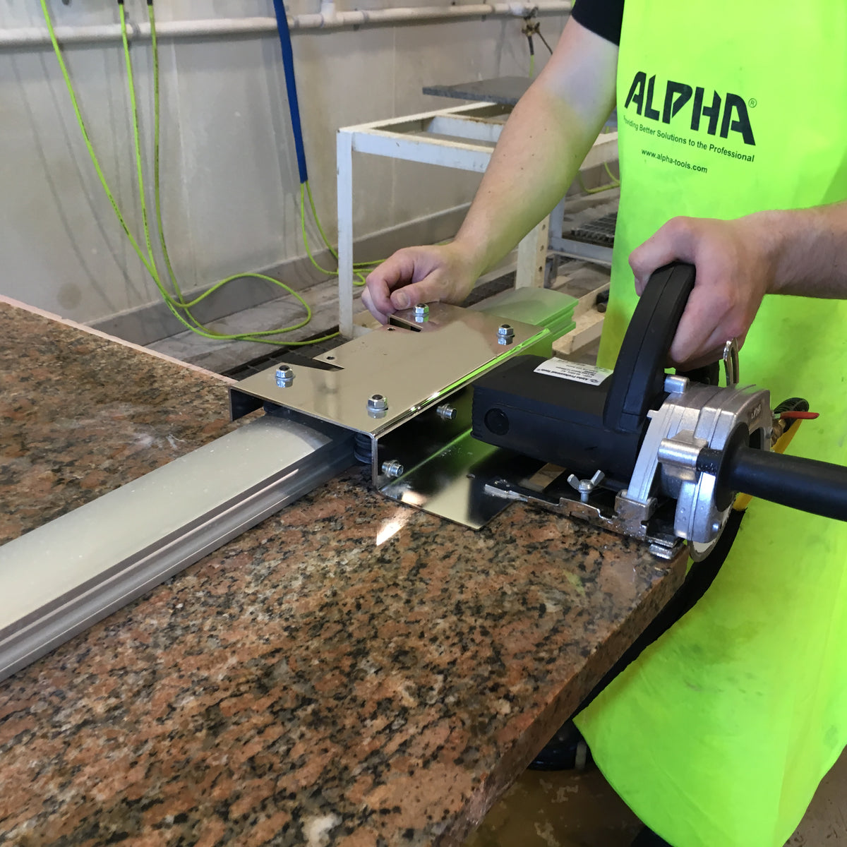 Person using the esc-125 countertop trim kit to cut granite countertop