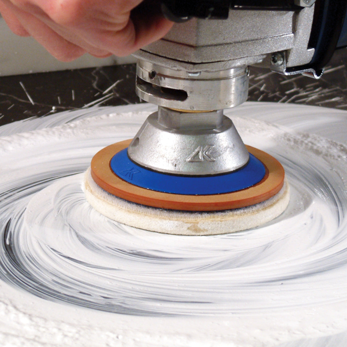 Person Polishing a countertop with an alpha felt wheel