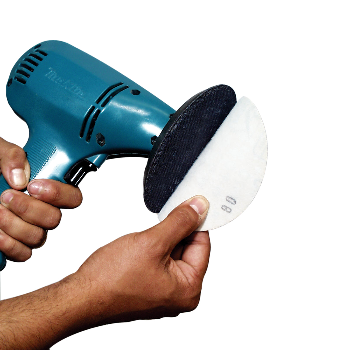 Person holding a Makita GV sander with Alpha GV backer pad attached and sanding disc