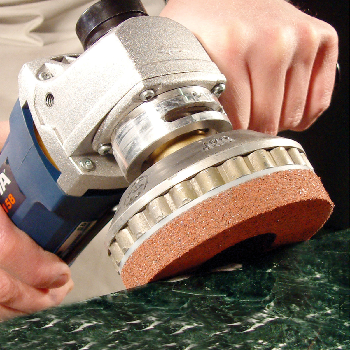Person using the Alpha PVA QC marble edge polisher on a marble surface