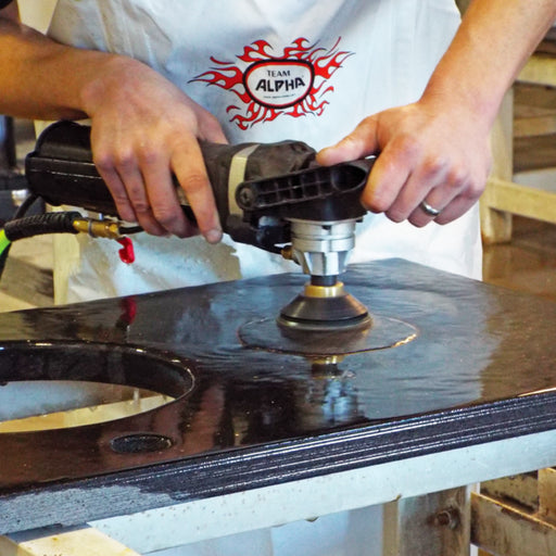 Person using the Alpha VSP-320 and Polishing pads to polish granite surface