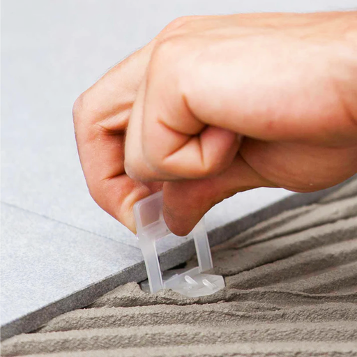 Raimondi 1/32" (1MM) Tile Leveling Clip Being Placed Under Porcelain Tile.
