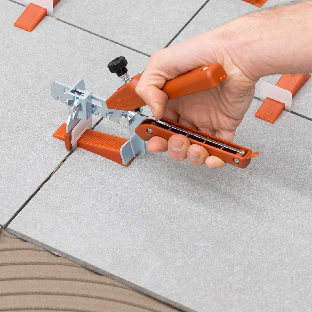 Raimondi 1/32" (1MM) Tile Leveling Clip and Wedge being tightened together by Floor Pliers.